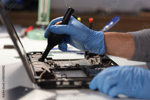 Male technician cleaning la...