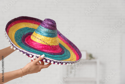 Woman with sombrero at home...