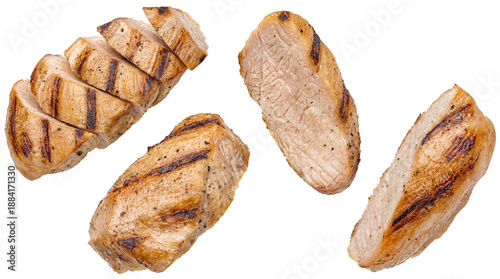 slices and pieces of grilled chicken breast, seasoned with pepper and grill marks, presented against a transparent background, suitable for culinary and advertising use.
