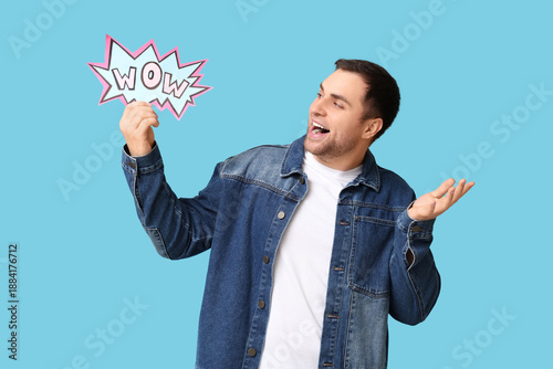 Surprised young man holding...