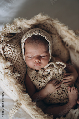 Cuadro en lienzo Newborn baby sleeping peacefully in soft textured blanket and knit outfit