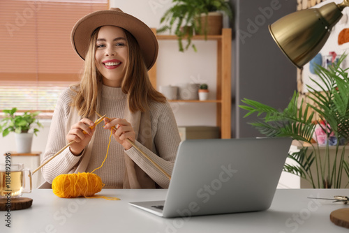 Young woman knitting with n...