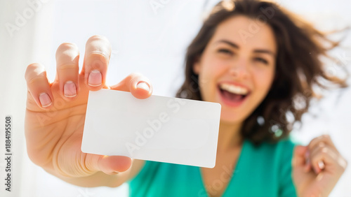 A smiling woman holding a blank white card mockup, perfect for inserting lottery ticket designs or marketing messages.