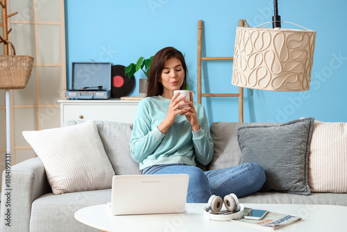 Young woman with cup of tea...