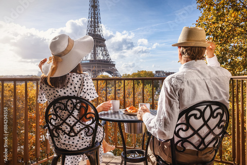 Photography Rear view of a romantic couple enjoying breakfast on a balcony with view of the