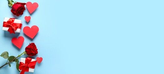 Roses, paper hearts and gift boxes on blue background with space for text. Valentine's Day celebration