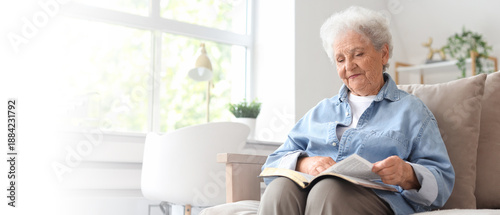 Senior woman on sofa readin...