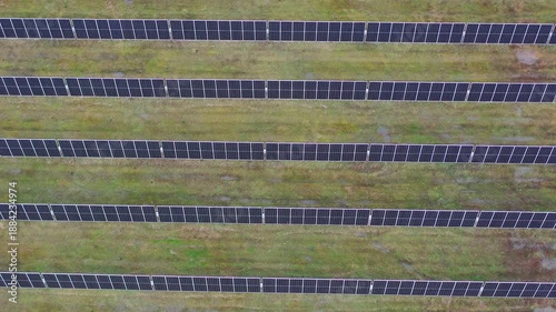 Top Down Aerial Movement Over Solar Panel Rows on Rural Land
