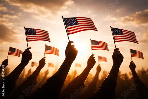 Silhouettes of People Holding American Flags at Sunset