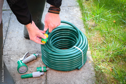A newly purchased garden hose, still neatly coiled and unused, 