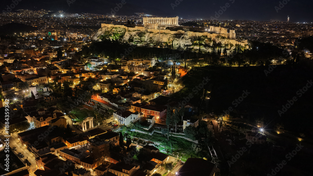 Naklejka premium Aerial drone night shot of amazing illuminated ancient market of Athens or Agora featuring temple of Hephaestus, picturesque Plaka district and Acropolis hill, Attica, Greece