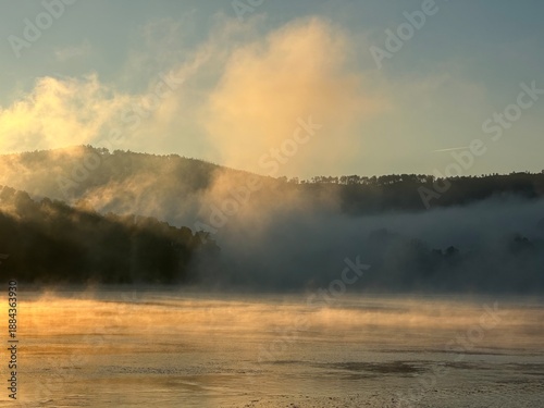 Golden mist over serene river Minho at sunrise near Eiras, O Rosal, Galicia, Spain, January 2025