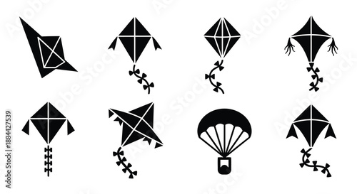 Collection of black silhouette icons depicting kites a parachute and a bird