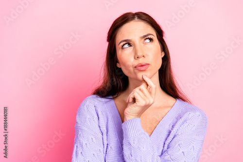 Tableau sur toile Contemplative young woman in a lavender sweater thoughtful pose against pink bac