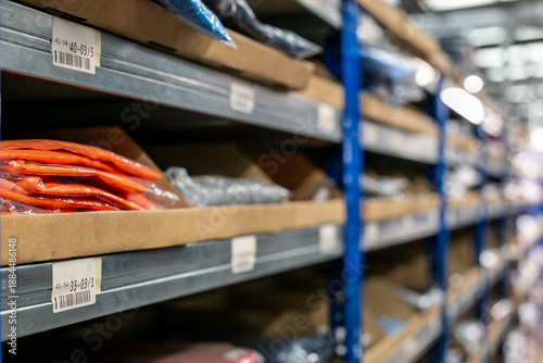 Industrial warehouse interior with metal shelves used for organised storage and picking of garments or stock