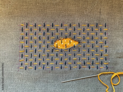 Billede på lærred This delicate Sashiko repair transforms a torn hole into an eye-shaped focal poi