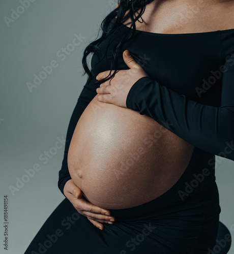 Close-up of pregnant woman belly with hands
