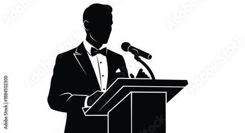 A silhouetted man in a tuxedo giving a speech at a podium