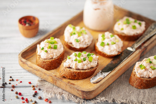 Tuna Pate Bruschetta with green onion, fish rillettes on wooden board