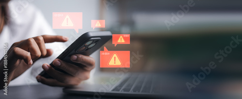 Konstfotografi Closeup hand holding smartphone with red warning alert icons