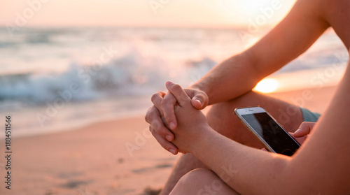 young couple holding hands with warm skin tones and gentle touch at sunset beach in a Valentine’s Day mood waves softly crashing behind them and soft breeze on skin golden hour lighting warm and natur