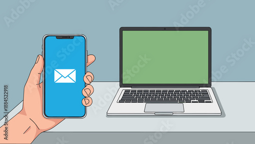A hand holding a smartphone displaying an email icon next to a laptop with a green screen on a desk.