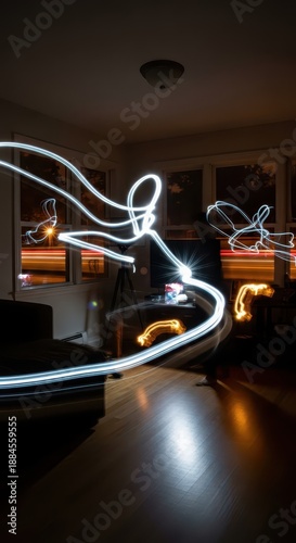 Dynamic abstract light trails swirl across a darkened interior space during a long exposure photograph