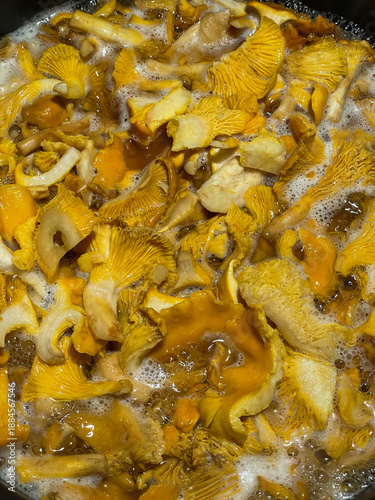 Parboiling funnel chanterelles in a frying pan
