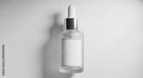 Elegant clear glass dropper bottle with a blank label, perfect for showcasing a new serum or essential oil in a minimalist beauty product advertisement