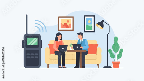 Two people working on laptops next to a radio in a cozy room