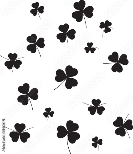 Scattered black clover leaves on a white background