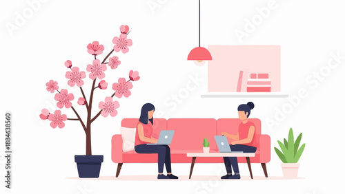 Two women working on laptops on a sofa with a cherry blossom tree