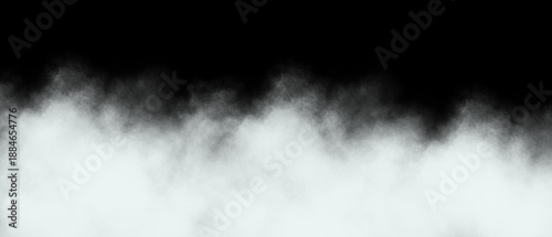 Fotografie White fog bank dramatically rising from a dark black background creating an ethe