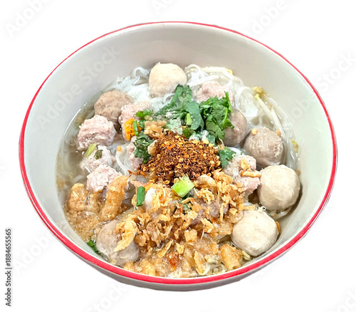 Thai noodle soup with meatballs and crispy toppings isolated on white background, popular Asian street food, hearty comfort meal, traditional cuisine photography concept