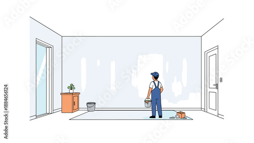 Dedicated painter in blue overalls and a cap stands in an unfurnished room, holding a paint roller and bucket, ready to finish painting walls.