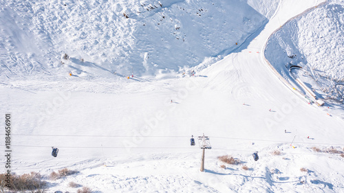 Aerial photo from dronet to Sierra Nevada ski resort on a sunny winter day in the mountains, Spain. Sierra Nevada is the largest mountain range near the city of Granada in Spain with snow. 