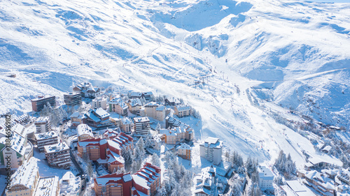 Aerial photo from dronet to Sierra Nevada ski resort on a sunny winter day in the mountains, Spain. Sierra Nevada is the largest mountain range near the city of Granada in Spain with snow. 