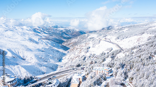 Aerial photo from dronet to Sierra Nevada ski resort on a sunny winter day in the mountains, Spain. Sierra Nevada is the largest mountain range near the city of Granada in Spain with snow. 