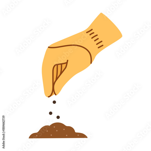 A hand in a rubber glove pouring seeds into a hole in the soil.