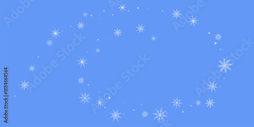 Snowfall. Falling white lacy snowflakes on a blue background. Christmas or New Year's background. 