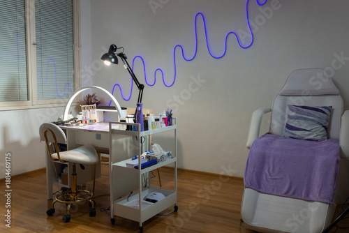 Foto Modern manicure workspace in beauty salon with professional table, lamps, tools and cosmetics