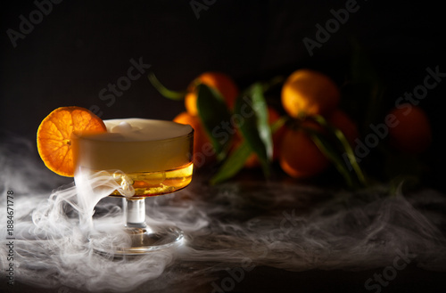 Elegant Cocktail With Orange Slice Garnish And Dramatic fresh misty effect In A Glassware Setting and Fresh Oranges in Background