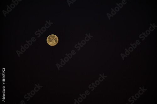 Full Moon Over a Quiet Night Sky, Golden Moon Illuminates the Dark Horizon