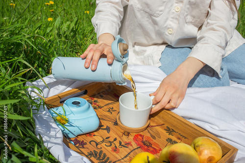 Woman holding a cup of tea picnic