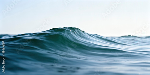 A beautiful ocean wave crests with turquoise hues, creating a serene yet powerful scene perfect for various design projects. This image evokes feelings of tranquility and natural beauty.