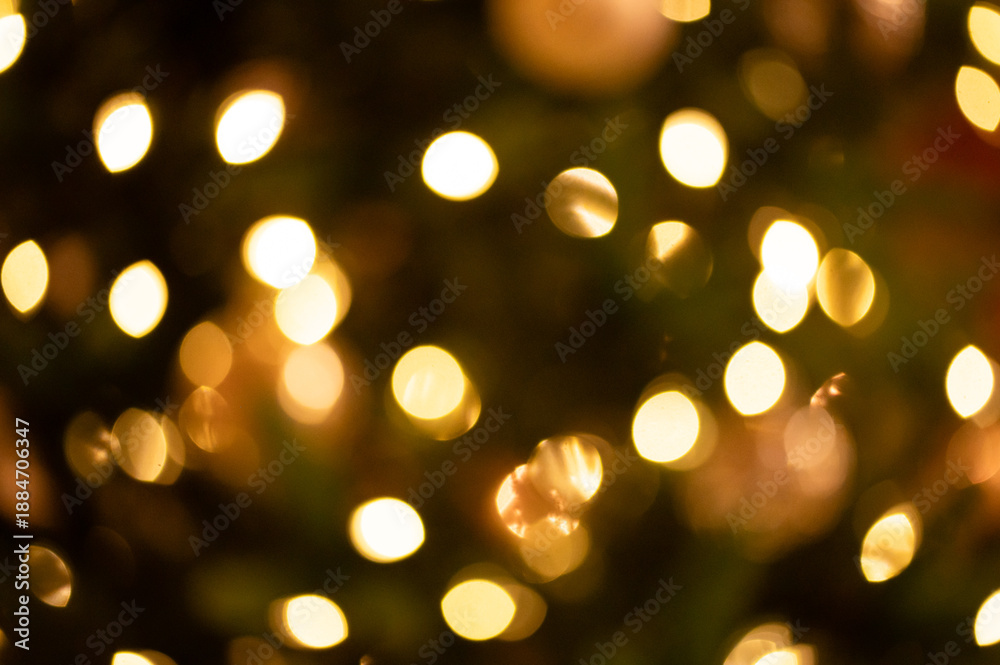 Obraz premium Gold bokeh Christmas lights with amber abstract background