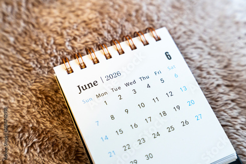Close-up of a calendar page displaying June 2026 with dates clearly marked, set against a soft background, symbolizing planning and organization for upcoming events.