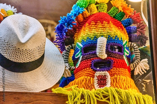Obraz na plátně Colorful Aya Uma headdress displayed alongside a traditional straw hat in a souv