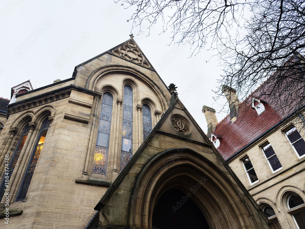 Fototapeta premium Manchester church facade with arched stained glass windows and gothic architecture