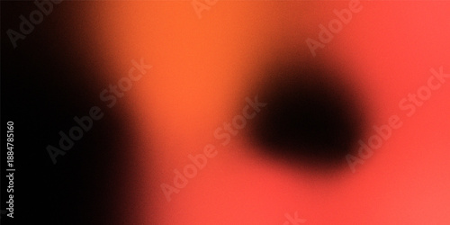 A blurred abstract image featuring a dark focal point set against a predominantly fiery orange background